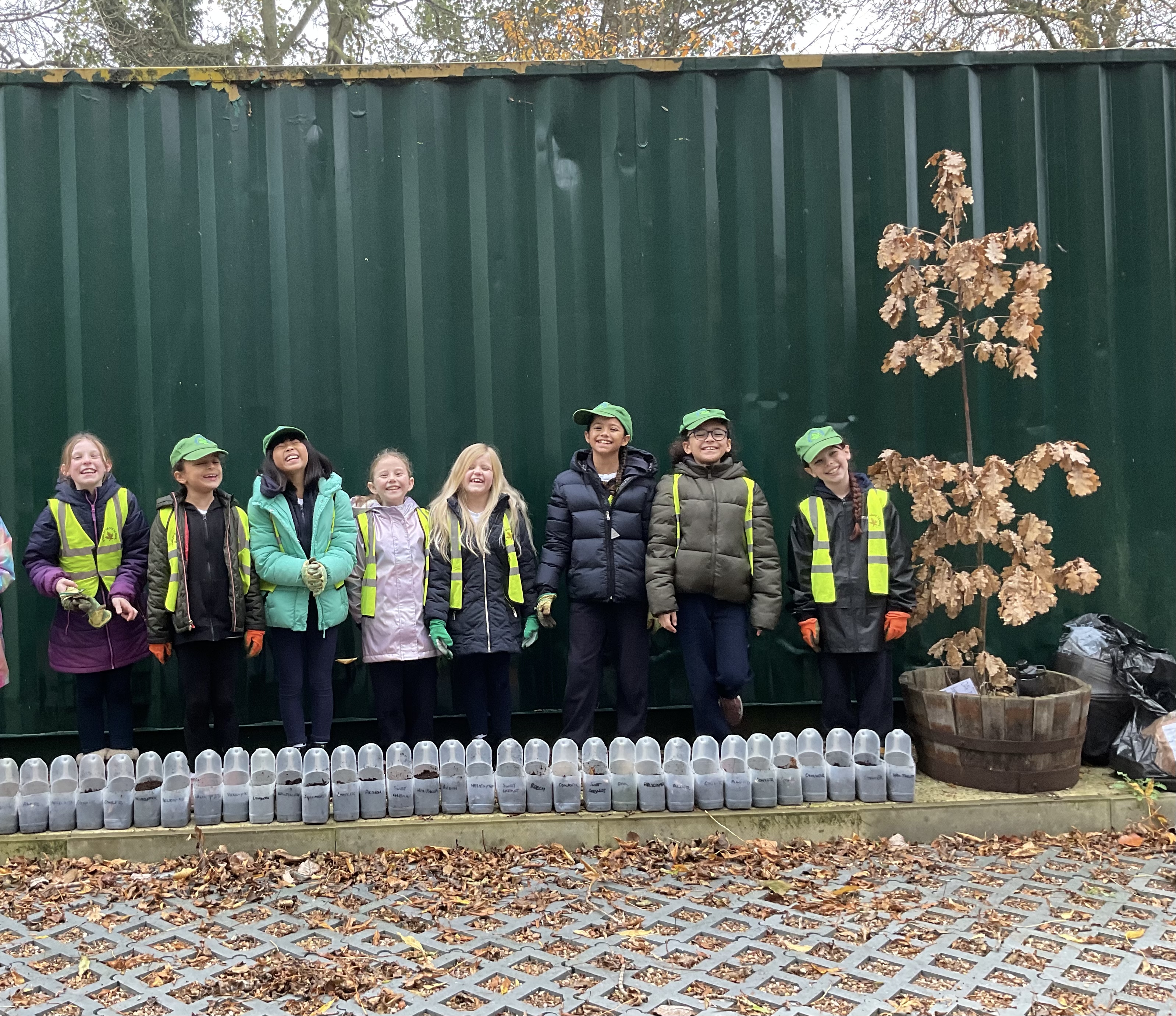 Trust sustainability team stood by a small tree